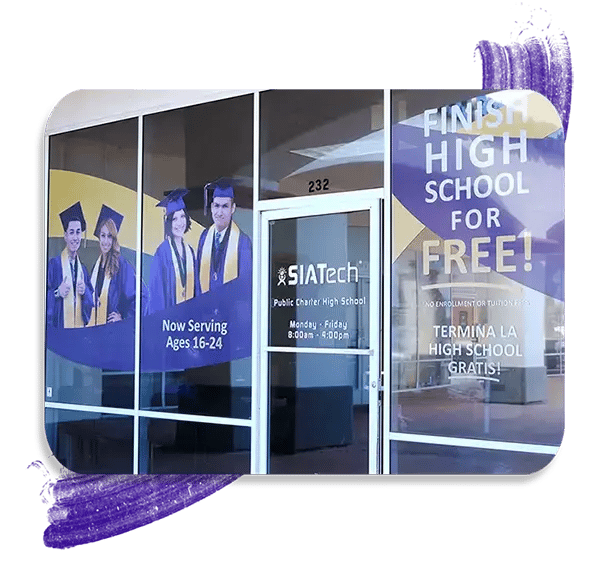 Front entrance of a SIATech classroom with graphics of high school graduates and school information.