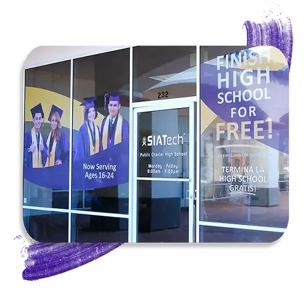 Front entrance of a SIATech classroom with graphics of high school graduates and school information.