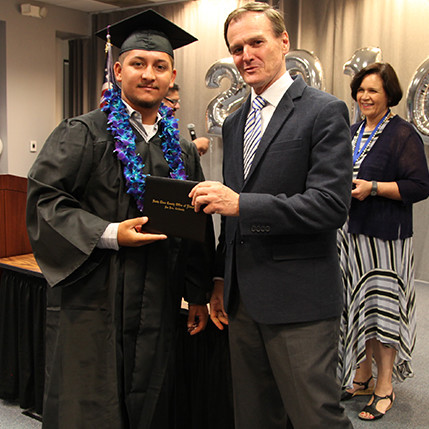 Alejandro Patino receiving his high school diploma and is part of the first graduating class at SIATech San Jose.